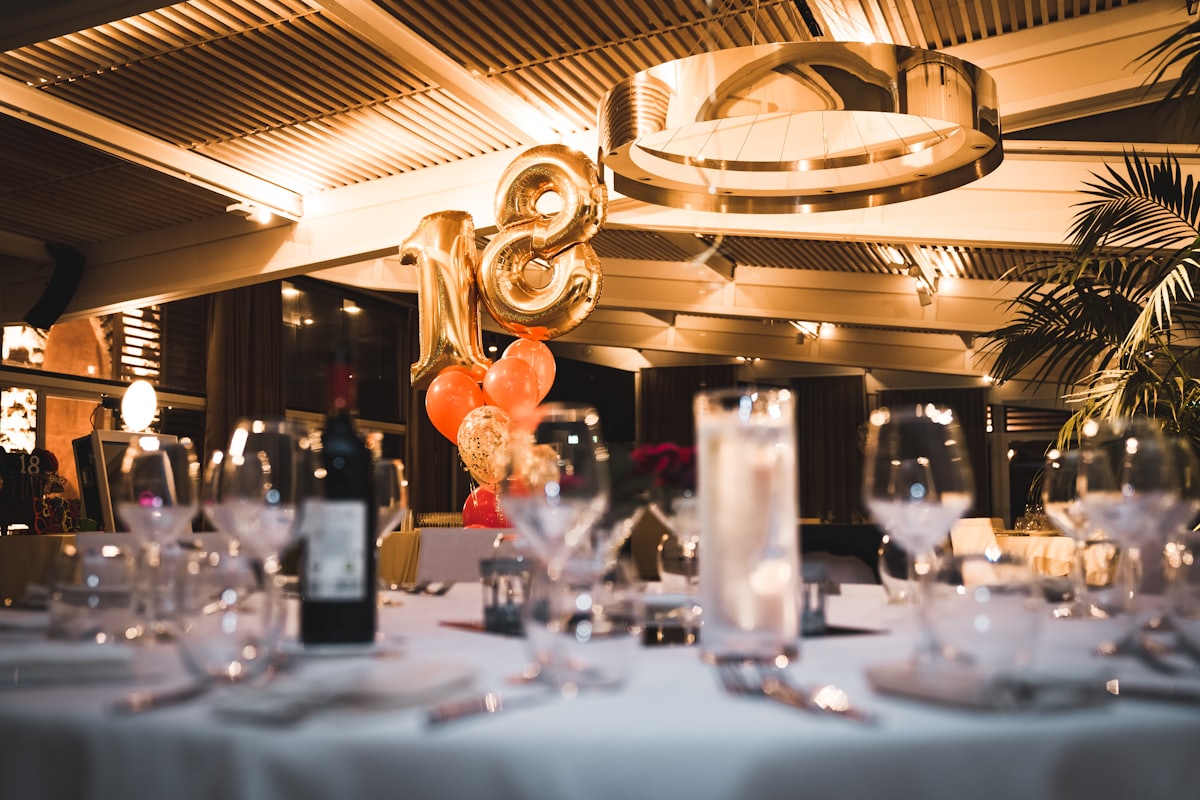 A styled brand activation space set with tables and balloons
